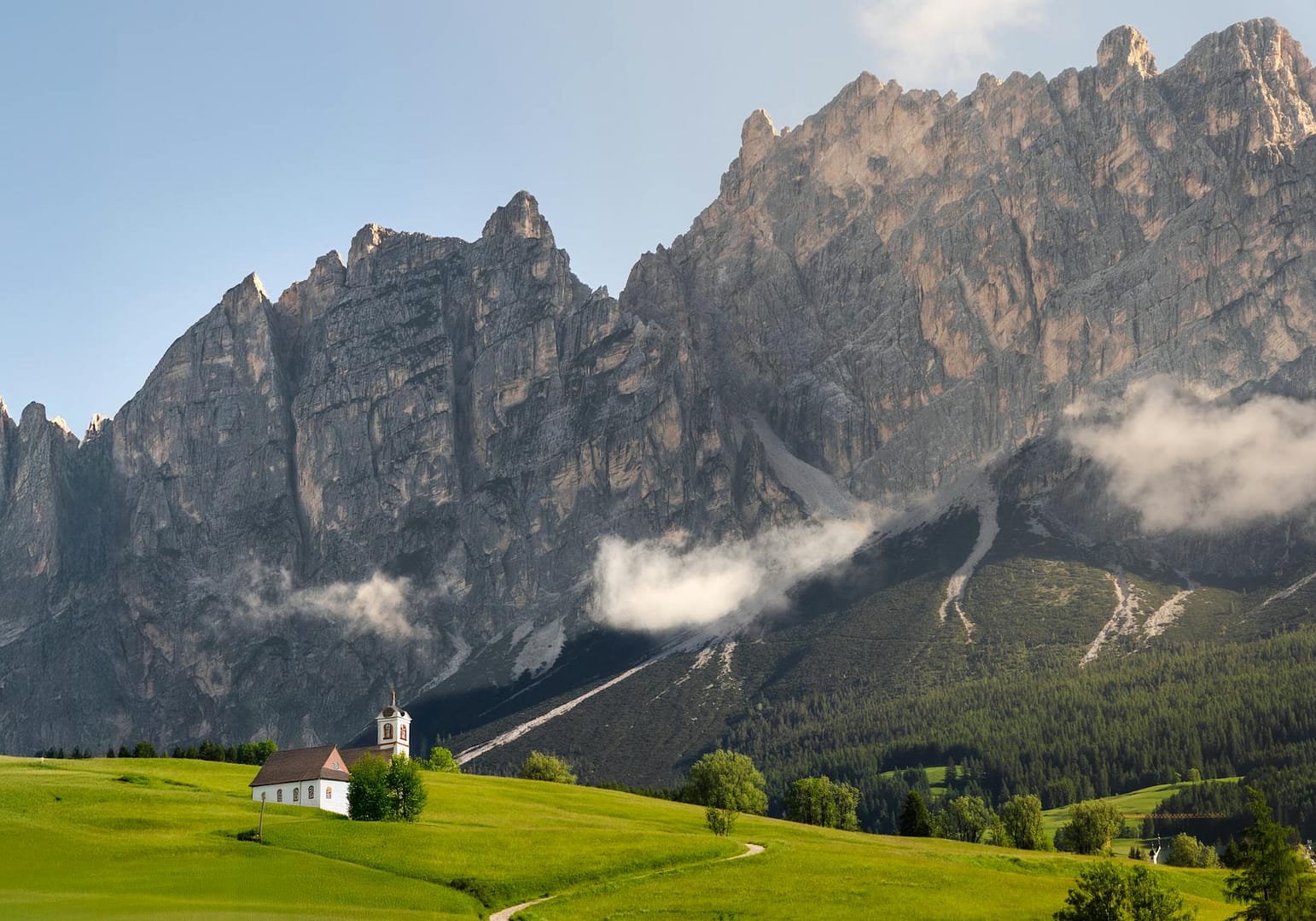 scenic church and mountain landscape in the dolomites